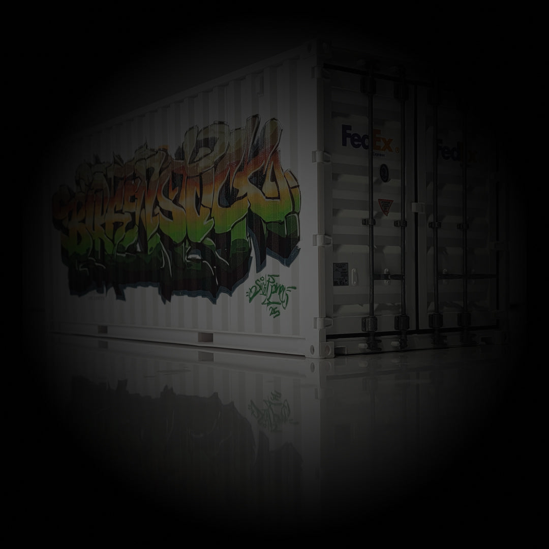 White shipping container with colorful graffiti and FedEx logo on a dark background